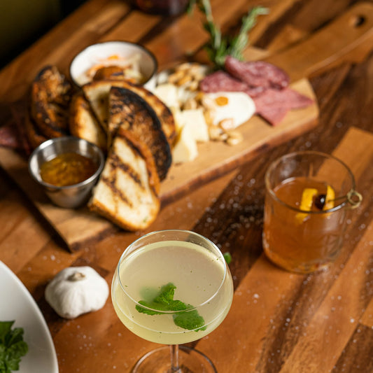Sharing board of cheese, charcuterie and toasted bread with drinks