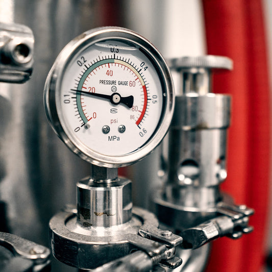 Pressure gauge on a stainless steel fermentation tank at the You + I brewery in Glasgow