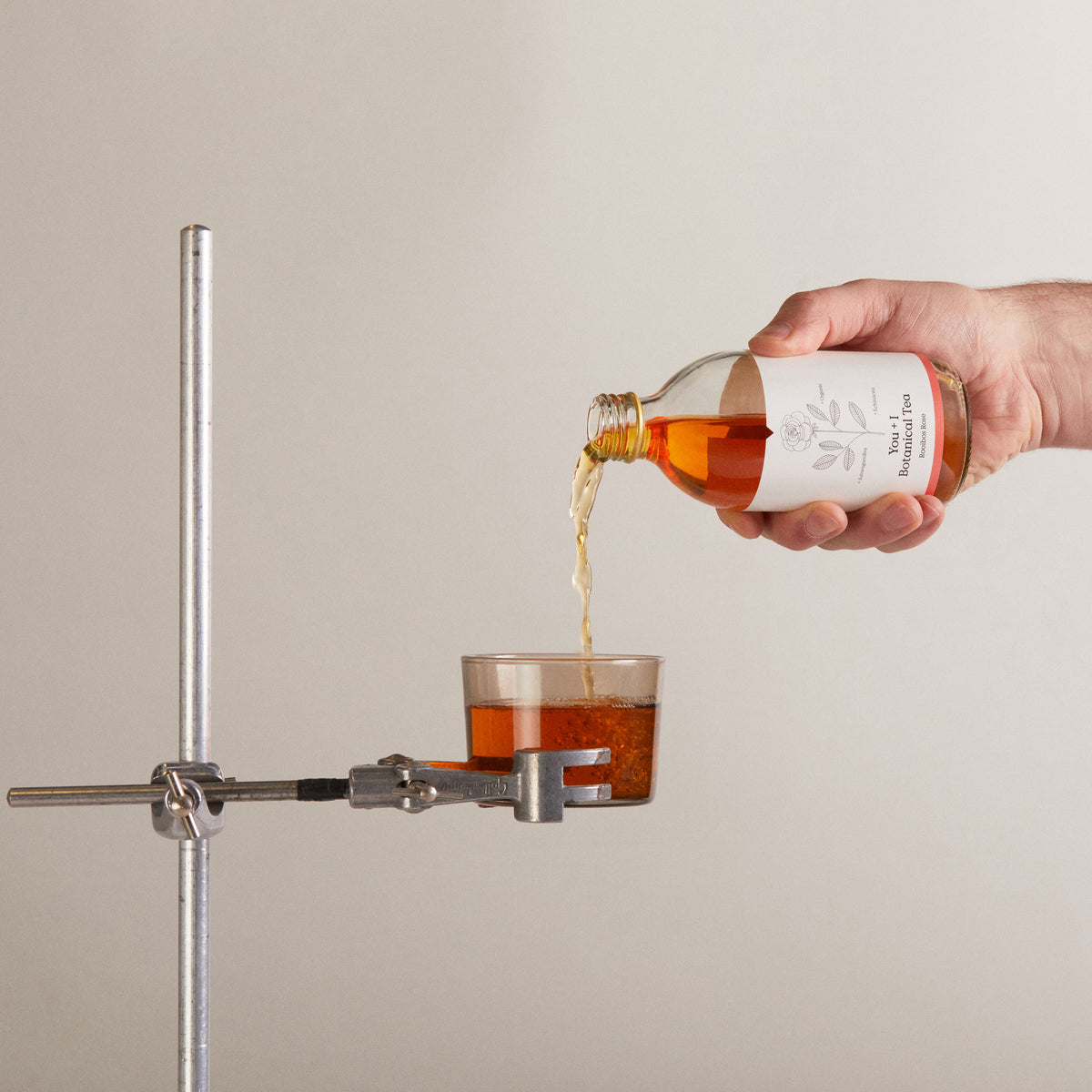 You + I botanical tea being poured into a glass